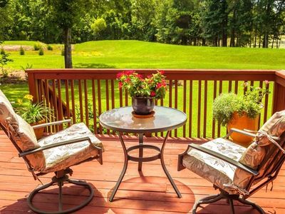 Wood deck on back of home with a bistro set Wood deck on back of home with a bistro set