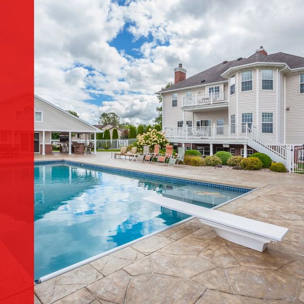 Apartment complex with large pool and a concrete pool deck