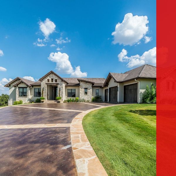 Home with concrete driveway with faux stone accents