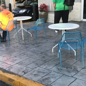 Restaurant patio with stamped concrete, and chairs and tables for sitting