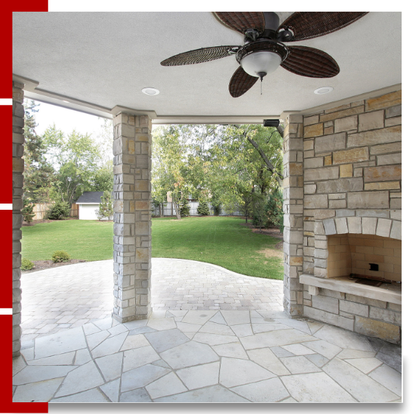 Home patio faux stone pavers, and natural stone pillars and a fire place
