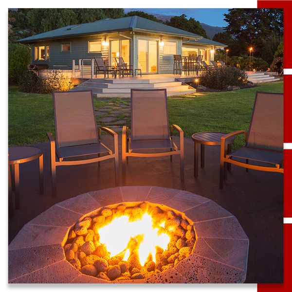 Concrete fire pit in home's backyard