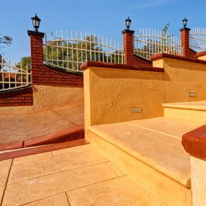 Walkway to home with tan brushed concrete