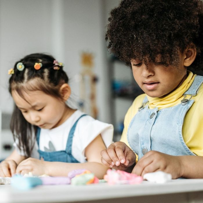 two students working next to each other on a project