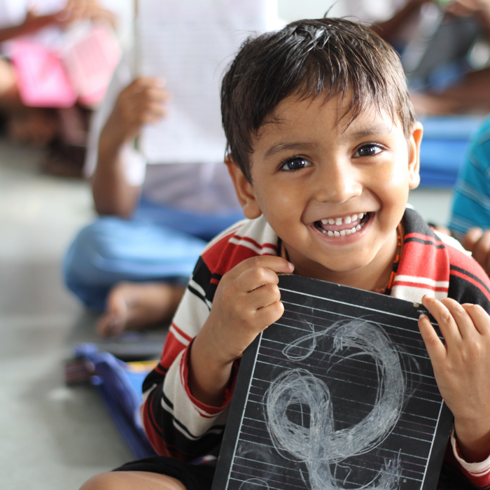 A child holding up a drawing