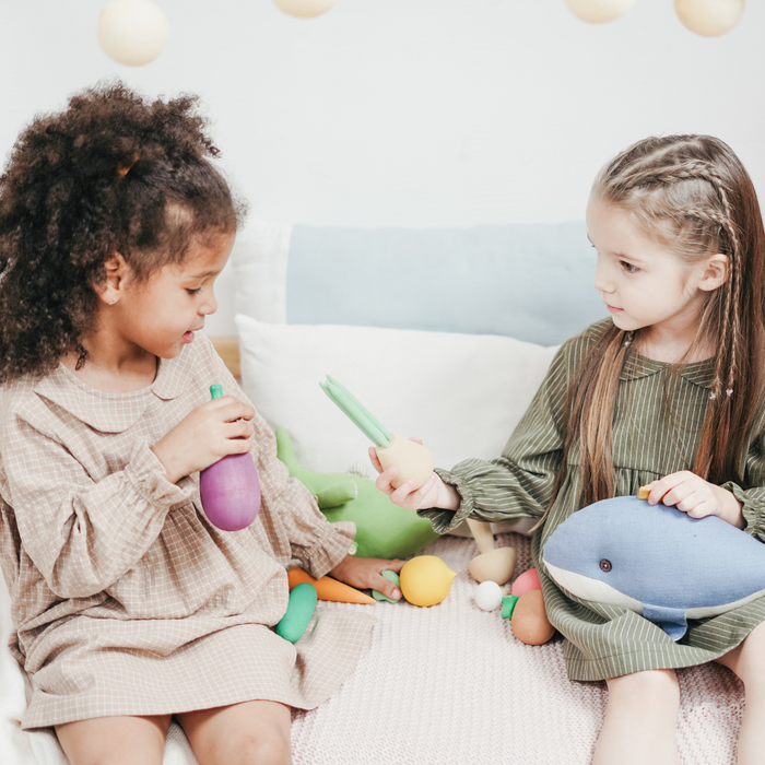 Two little girls playing with toys