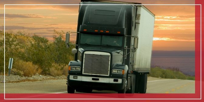 Semi truck driving on road alone