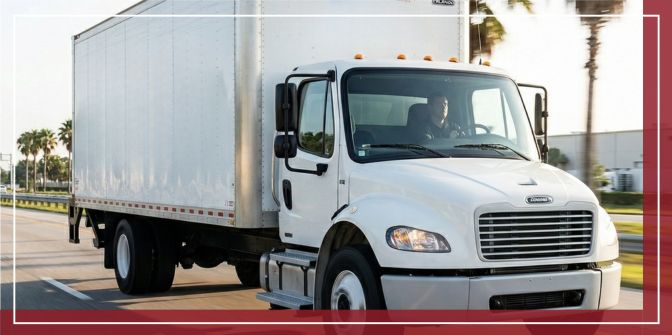 A clean white EDI Express Inc. box truck accelerating onto an Orlando highway in the early morning, demonstrating faster transit times.