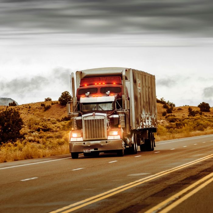 A semi truck driving down the road