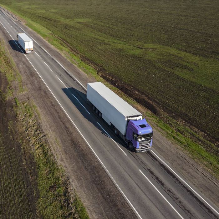 A semi truck driving down the road