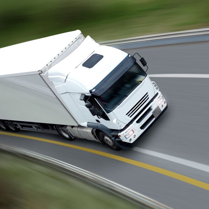 white truck speeds down road white truck speeds down road
