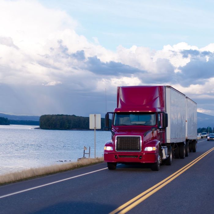 Semi truck next to water Semi truck next to water