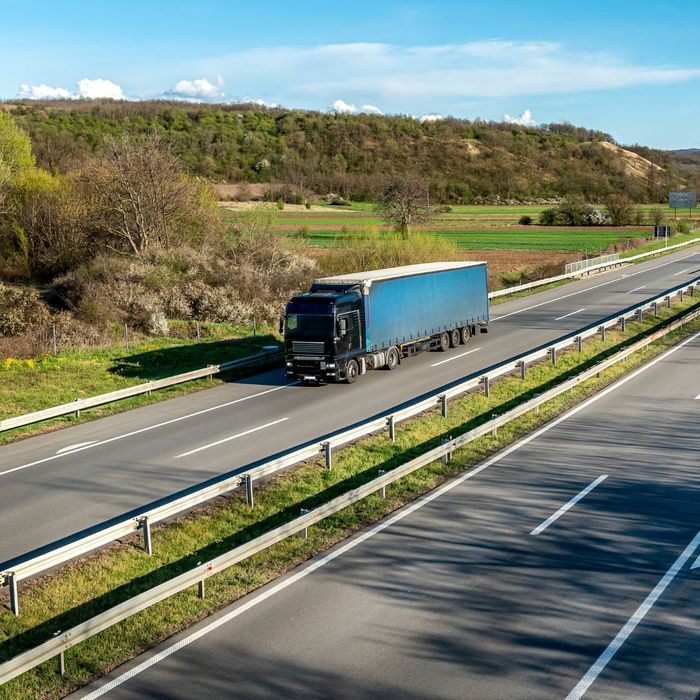 A semi truck driving down a highway