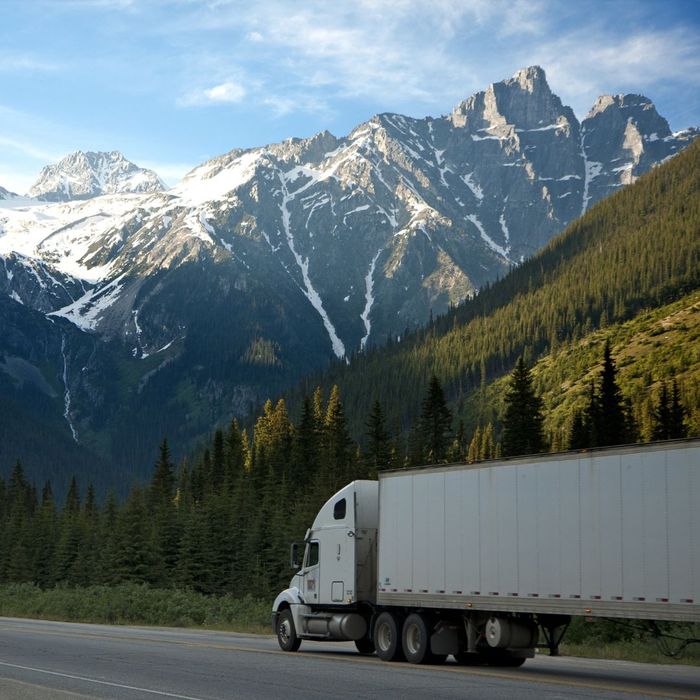 A semi truck driving into the mountains