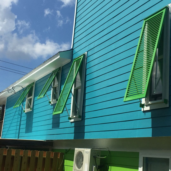 Bright green shutters on a blue home