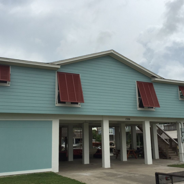 Red shutters on a light blue home