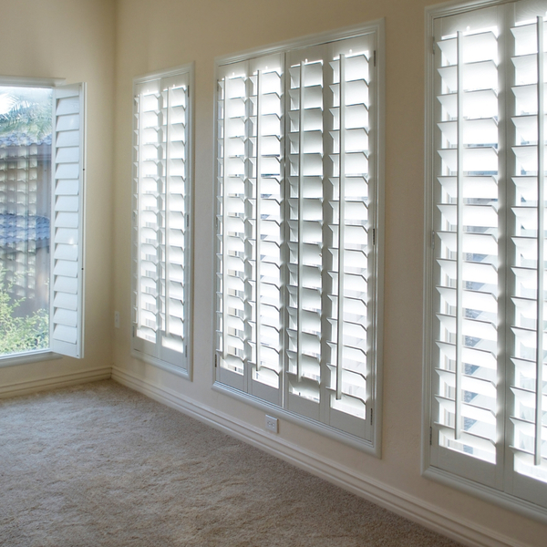 Sun shining through shutters into a room