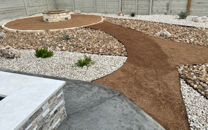 an intricate landscaping walkway and rock design with plants