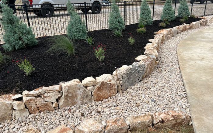 a combination of rock and garden landscaping with Xeriscape plants