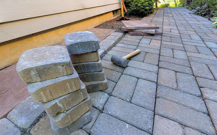 a stone path and pavers being placed