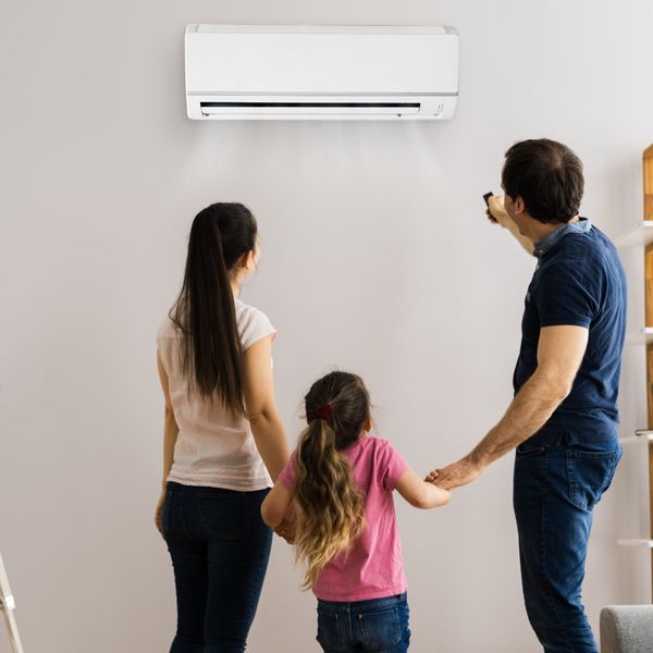 Family standing in front of AC