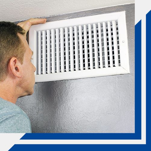 man looking closely at vent