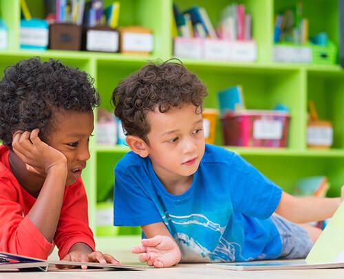 two young boys reading
