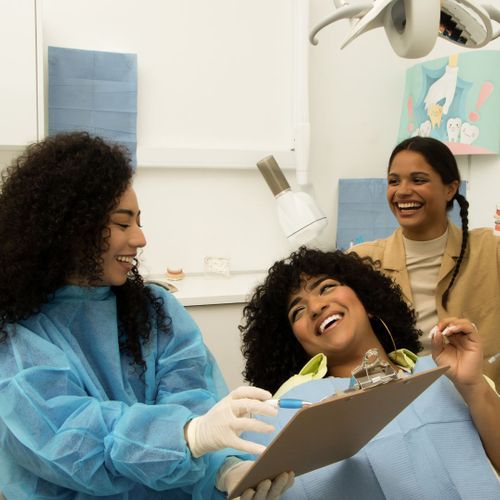 a woman smiling with her dentist Tips for Managing Dental Anxiety.jpg
