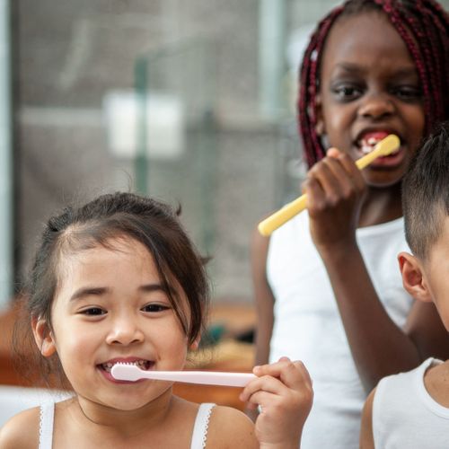 small kids with toothbrushes small kids with toothbrushes