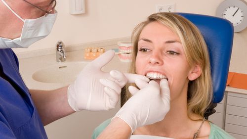 dentist trying braces on a client