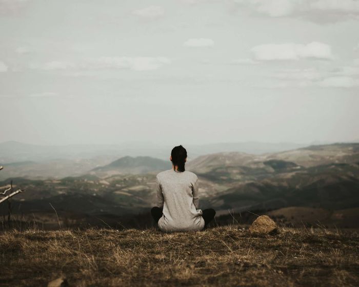 woman sitting in the mountain and healing from emotionally immature parents