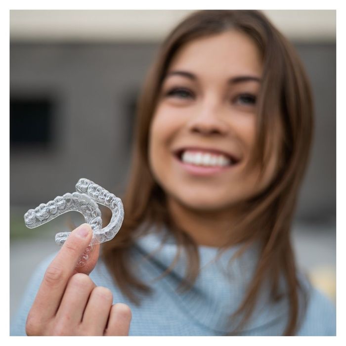 woman holding retainers