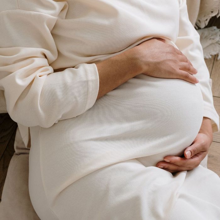 pregnant woman holding stomach