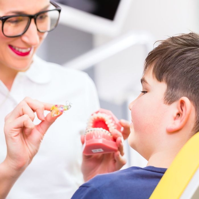 orthodontist working with boy