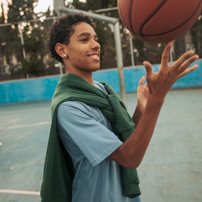 teen playing basketball teen playing basketball