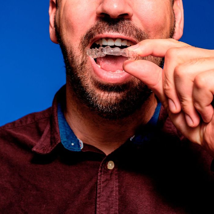 man removing invisible aligners