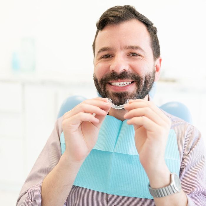 man in dentist chair with invisible braces