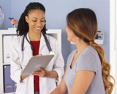 doctor speaking with female patient