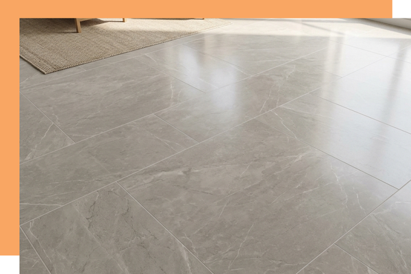 Large format porcelain floor tiles shining under natural sunlight in a residential living space.