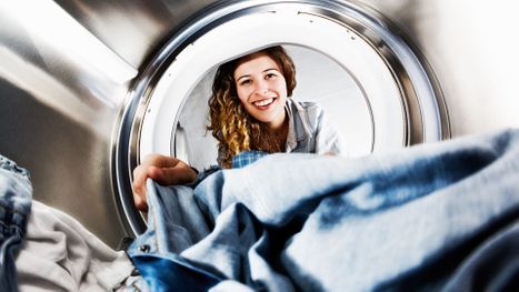 woman taking clothes out of dryer