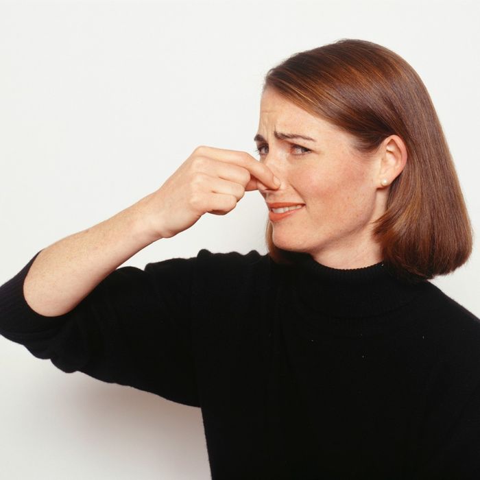 woman holding her nose