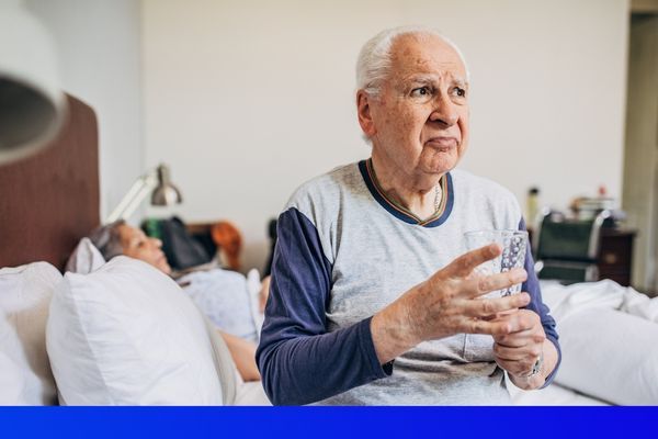 elderly man sitting in bed