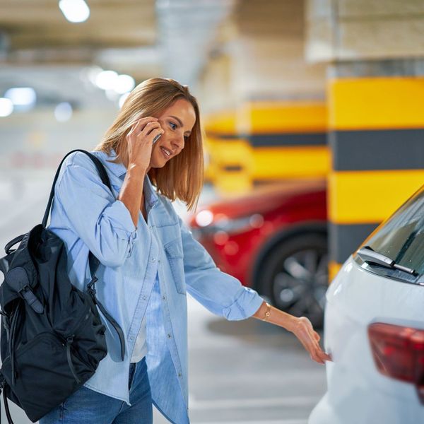 lady trying to open the trunk of her car