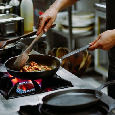 cooking on stove in commercial kitchen