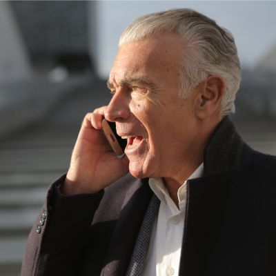 older business man on the phone