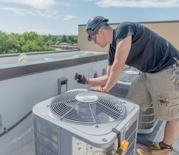 a HVAC professional working on a commercial unit