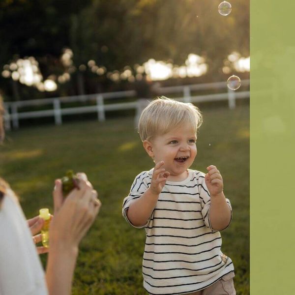 child laughing at bubbles