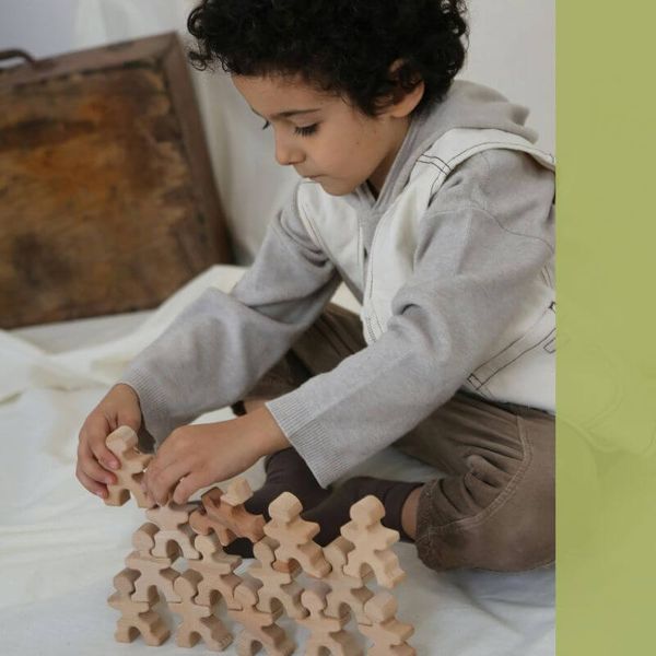 child with wood puzzle