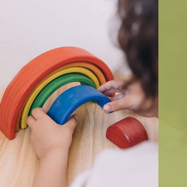 child with rainbow puzzle