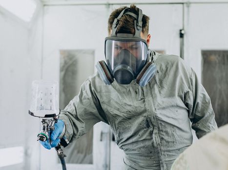 Image of a man spraying on the coating